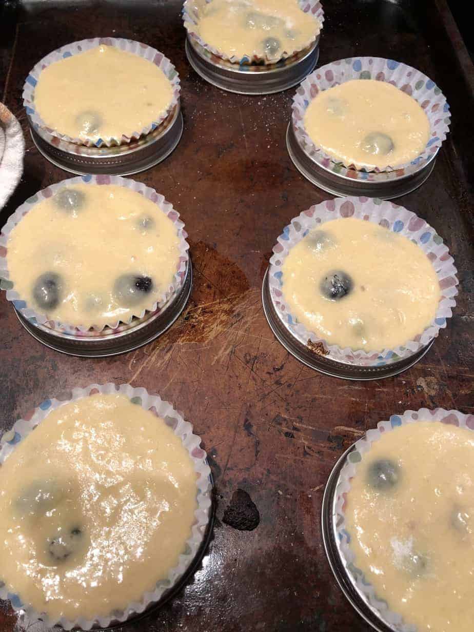 blueberry muffin batter in paper muffin cups