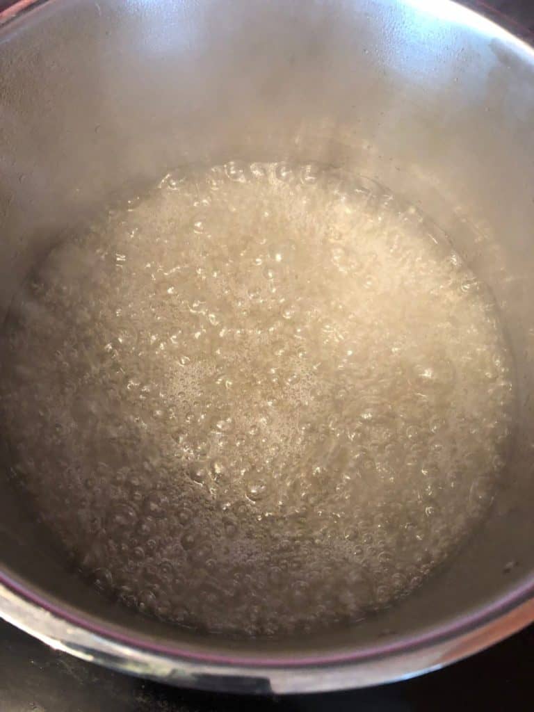 water and sugar in a saucepan coming to a boil