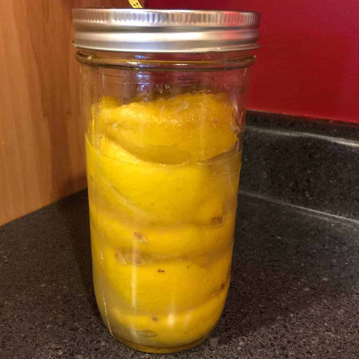 Lemons and salt in a wide mouth canning jar